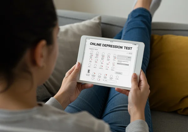 Person taking an online depression test on a tablet