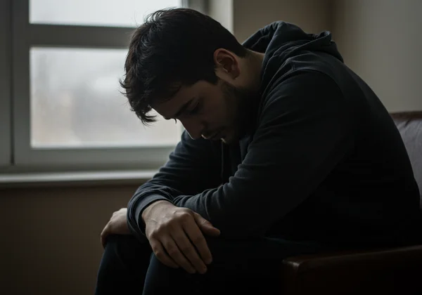 Person showing signs of fatigue, loss of interest, and sadness.