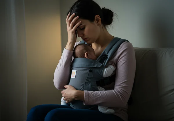 Mother looking sad, symbolizing emotional PPD symptoms